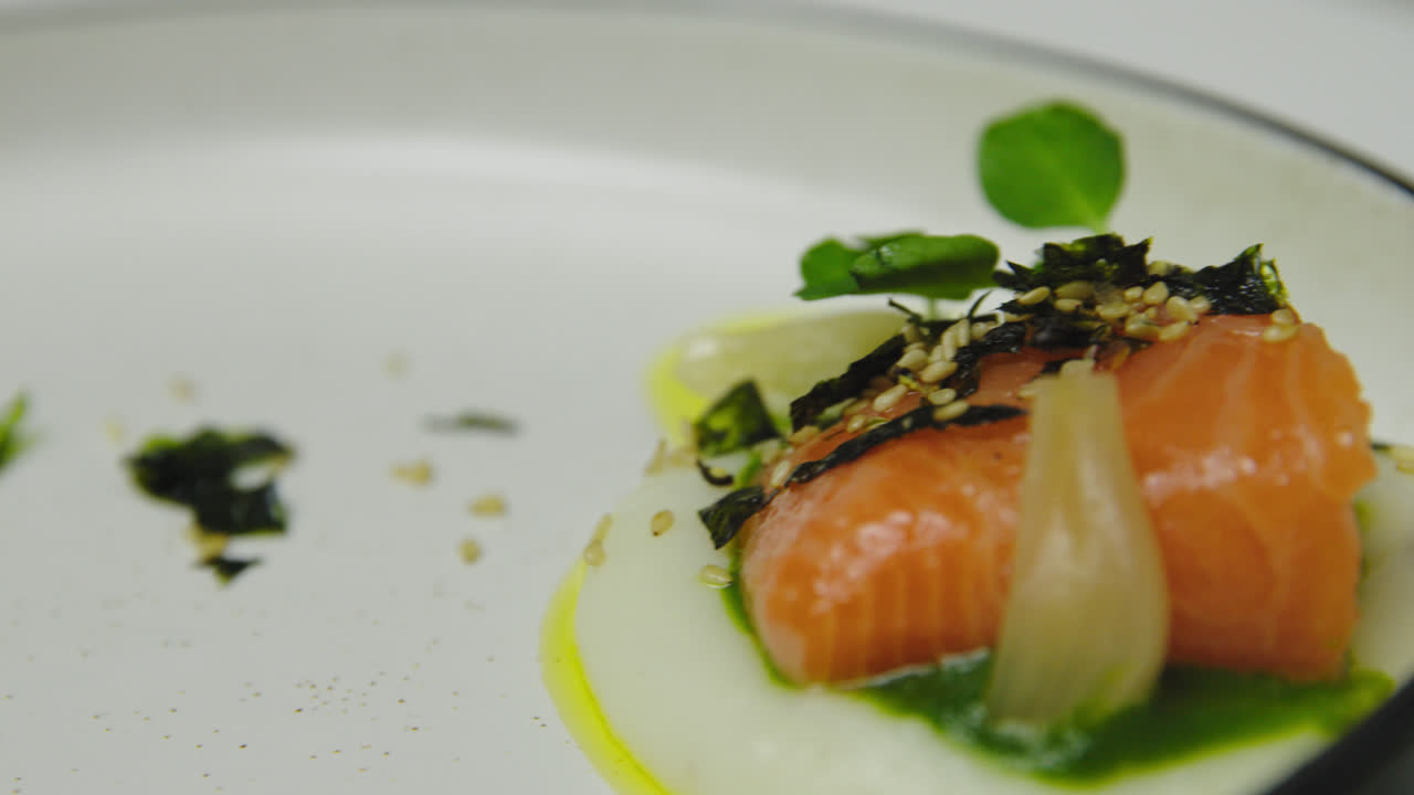 고급 레스토랑에서 야채와 토핑을 곁들인 고귀한 연어 필레의 팬 샷을 닫습니다.