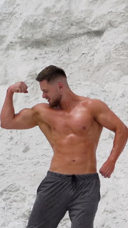 muscular man posing on mountain. muscular man with perfect body posing on mountain vertical video