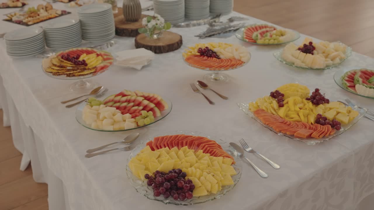 Assorted sliced tropical fruits arranged on elegant buffet table