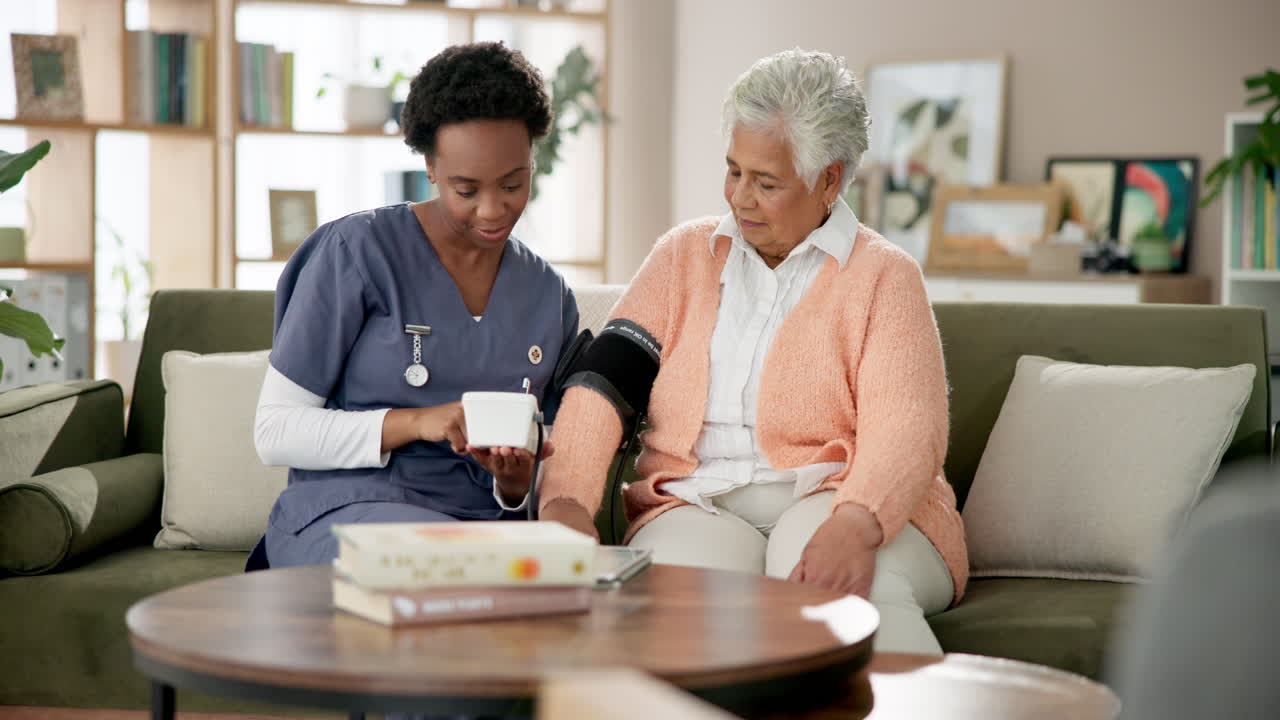 Nurse checking blood pressure of an elderly woman
