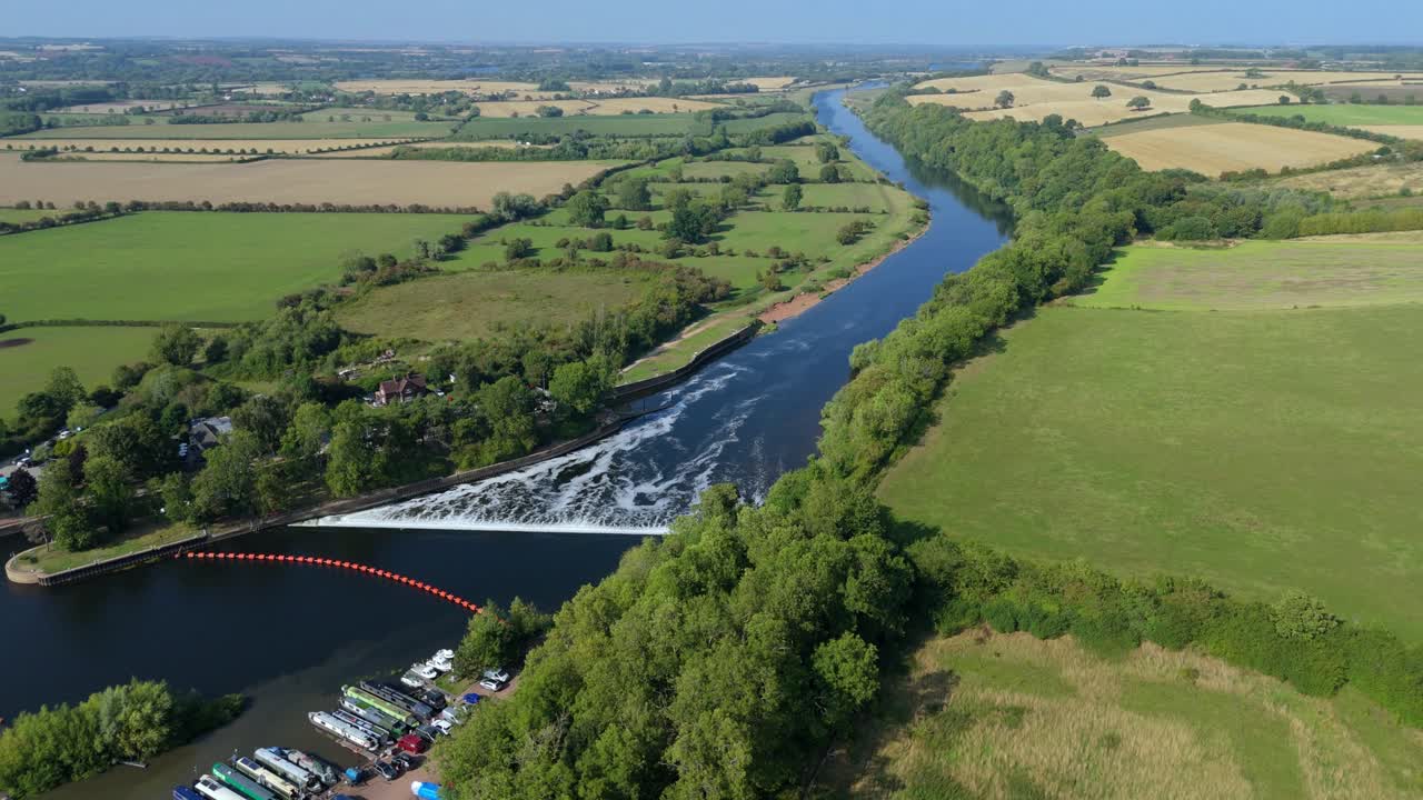 Title: Aerial drone sunset over Gunthorpe Weir and River Trent Nottinghamshire with navigation canal and rural green English countryside landscape summer evening