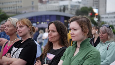 people watching an event in the city