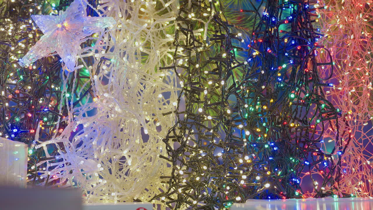 Close-up of colorful blinking Christmas lights with star-shaped decorations in vibrant holiday decor, the lights blink in a festive display, creating a magical holiday ambiance in the store