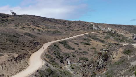 solo bicyclist riding dirt road on catalina island backcountry california