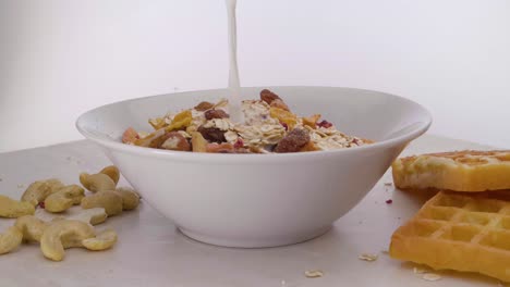 Static-rotating-shot-of-vegan-muesli-with-various-fruits-and-wafers-with-cashew-nuts