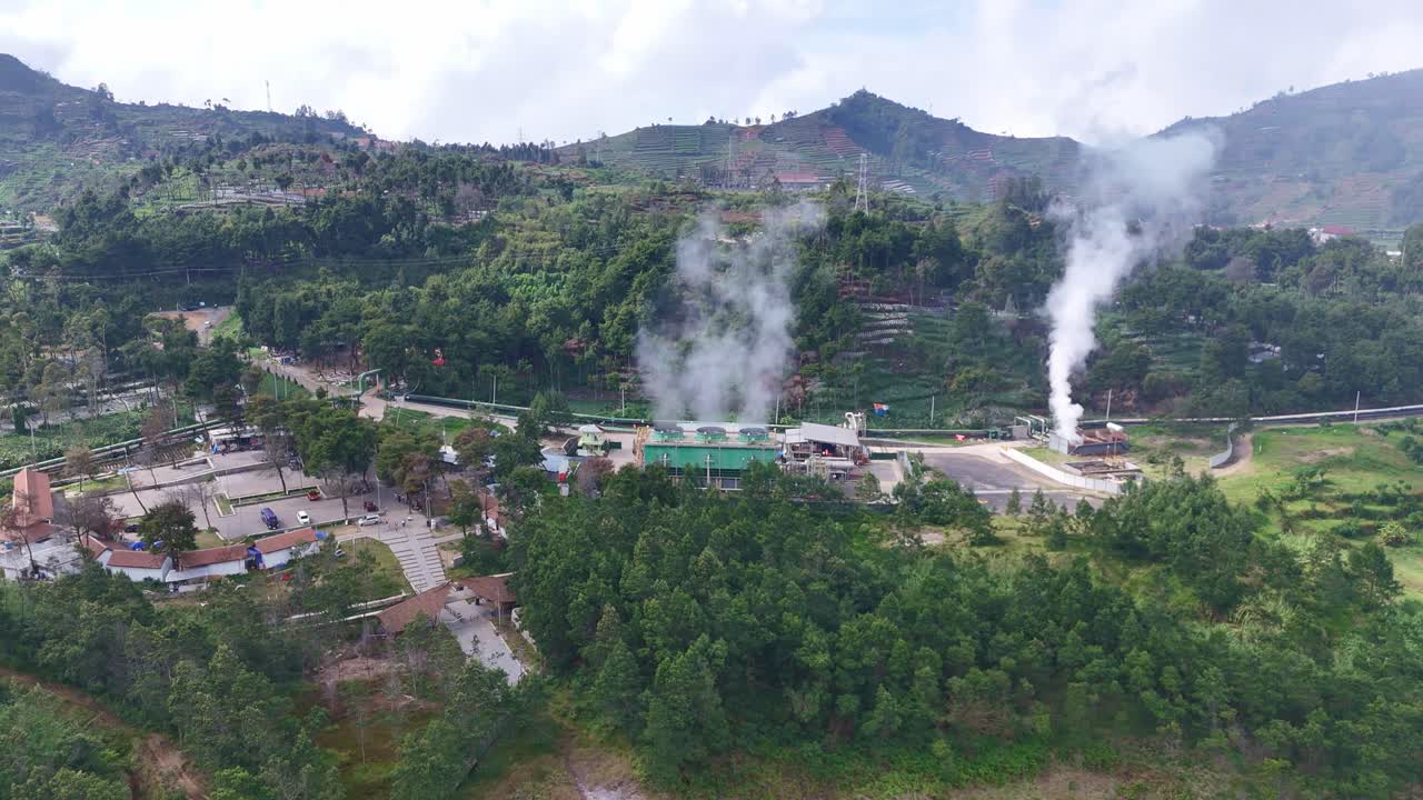 Aerial shot of a renewable energy facility utilizing geothermal resources, showcasing sustainable power generation in a rural landscape