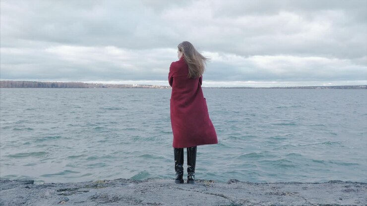Woman in Red Coat by the Lake