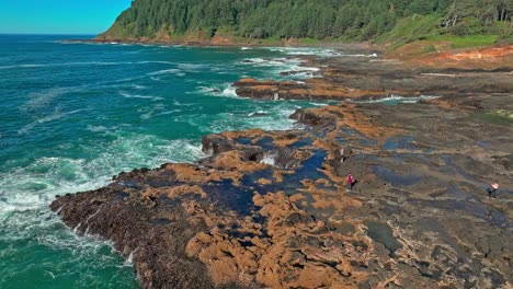 Located-in-the-Cape-Perpetua-Scenic-Area,-just-three-miles-south-of-Yachats-Oregon,-Thor's-Well-is-a-bowl-shaped-hole-carved-out-of-the-rough-basalt-shoreline