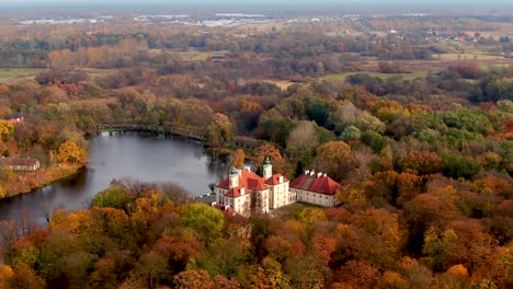 scenic aerial flight over mist above forrest lake at sunrise, 4k footage