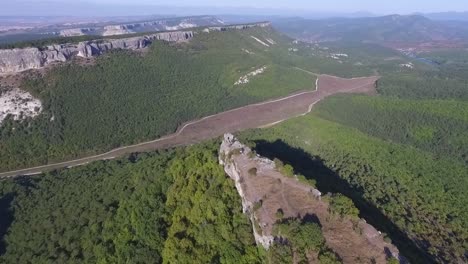 aerial view of mountainous landscape with forest and valley