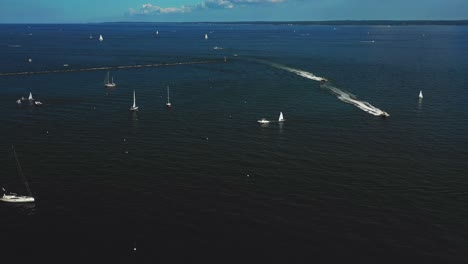 drone pan footage of yachts and boats in a harbor in the northeast on a summer day in 4k