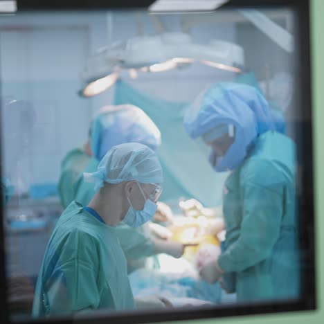 specialists in medical uniform are doing an operation in hospital. medical team operation in modern operating room