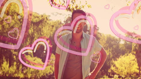 outdoors, man smiling with pink heart animation overlay in background
