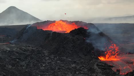 super slow-motion footage of a volcanic eruption near reykjavik, iceland, showing lava explosions and molten flow from the crater.