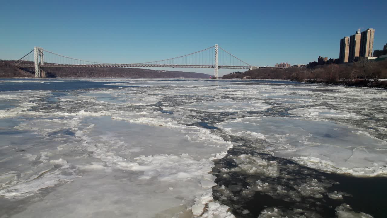 Low aerial of ice on the Hudson River with George Washington Bridge, 4K