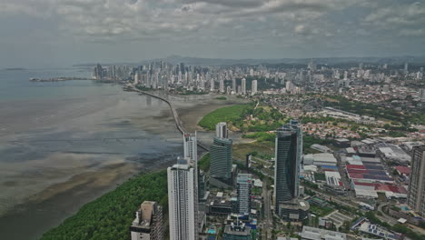 panama city aerial v85 flyover condominiums along the shore at costa del este with pan-american highway leading to central district capturing downtown cityscape - shot with mavic 3 cine - march 2022