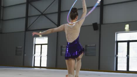 Female-gymnast-performing-at-sports-hall