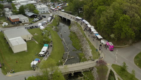 AERIAL---Dogwood-Festival-and-Sager-Creek,-Siloam-Springs,-Arkansas,-forward