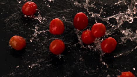 cherry tomatoes falling into water