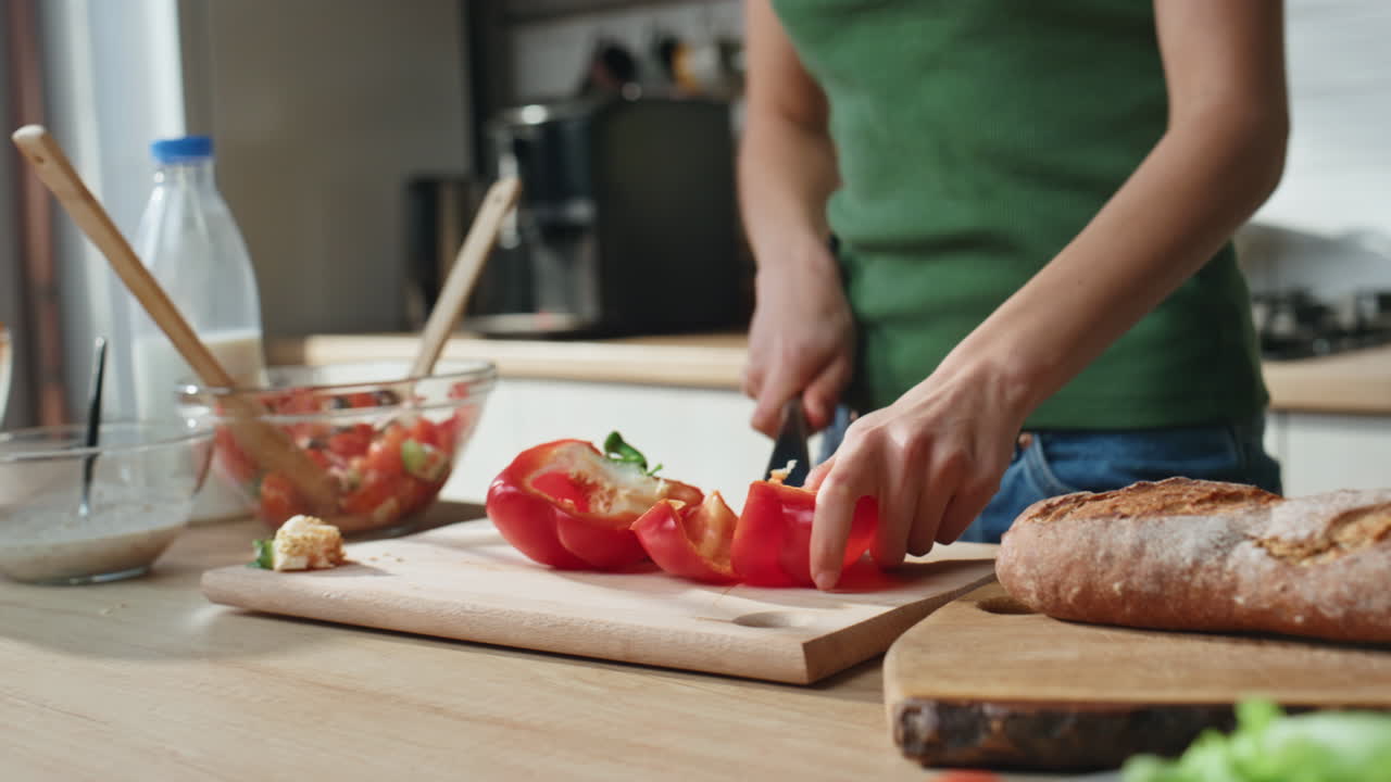 Woman preparing healthy salad in kitchen