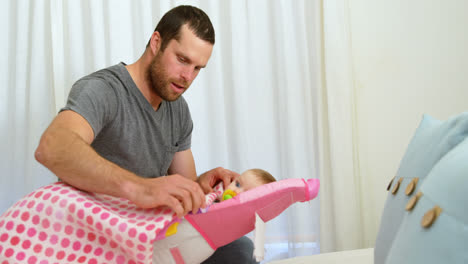 father putting blanket on his baby 4k