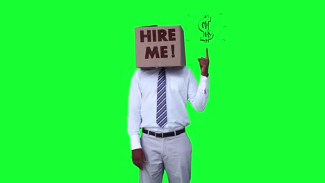 businessman wearing hire me box and pointing on dollar sign against greenscreen