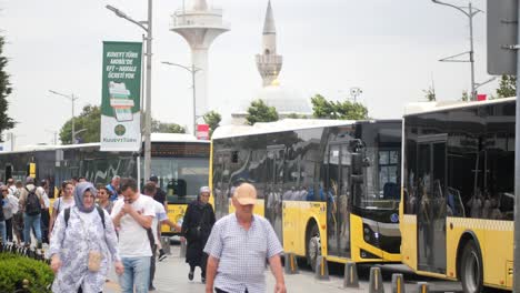 people waiting at a bus stop in a city