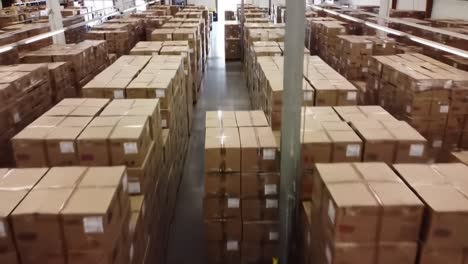 aerial view of an organized warehouse filled with neatly stacked cardboard boxes, showcasing efficient logistics and inventory management in action