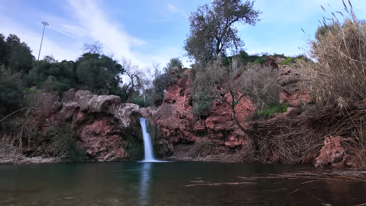 Timelapse - Pego do Inferno waterfall cascading into serene pool, Tavira Portugal