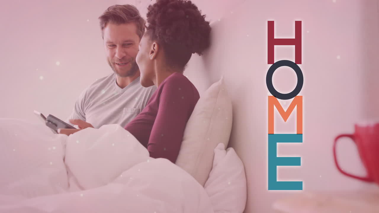 Animation of home text over diverse couple using smartphones on bed