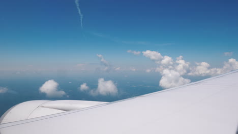 view from the window of the airliner on the wing of the aircraft with a large engine and beautiful c