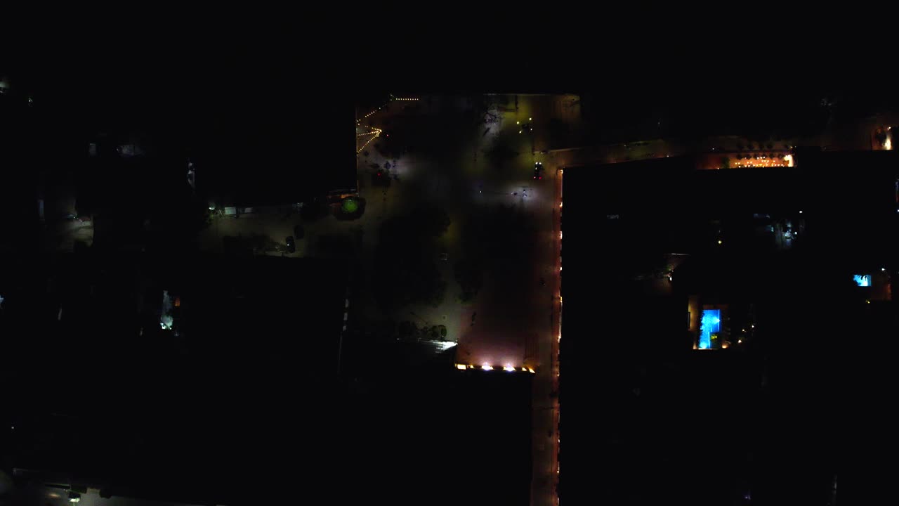 As the drone rises, the expansive view of Mompox at night unfolds.