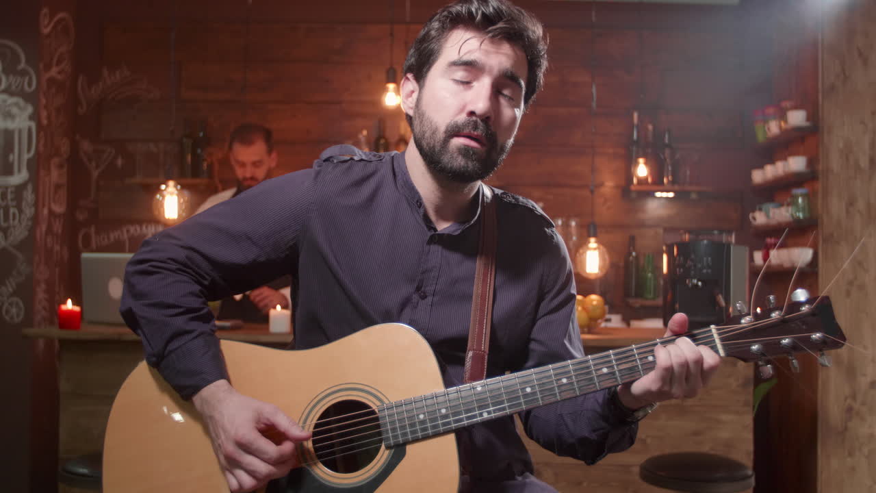 Musician playing guitar in a bar
