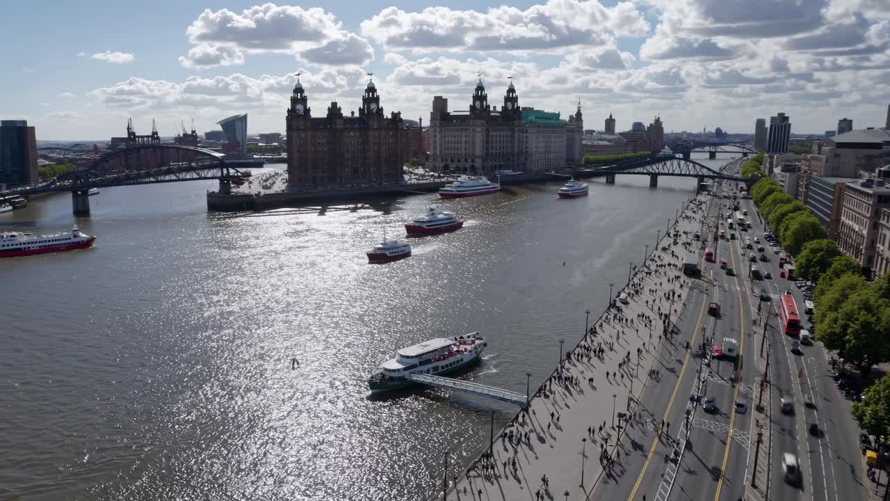 Aerial video view of a bustling river with boats and a cityscape
