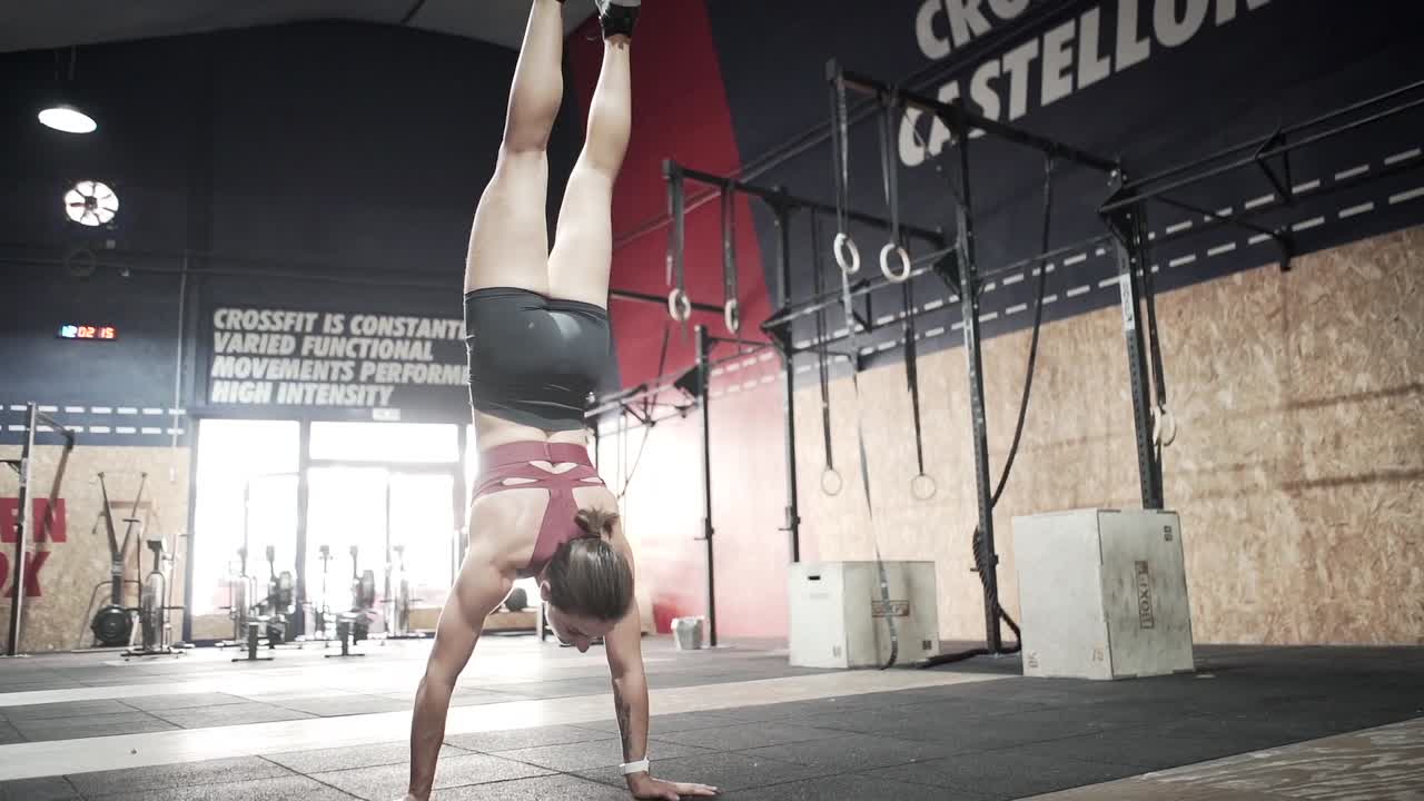 Woman Performing Handstand in a CrossFit Gym