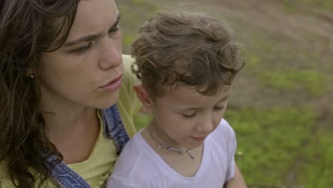 mother talking to little son outdoors