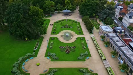 thabor gardens with fountains and flower beds, rennes in france. aerial drone backward ascending