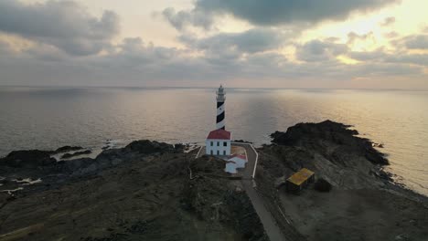 cloudy sunset with secluded lighthouse in the foreground