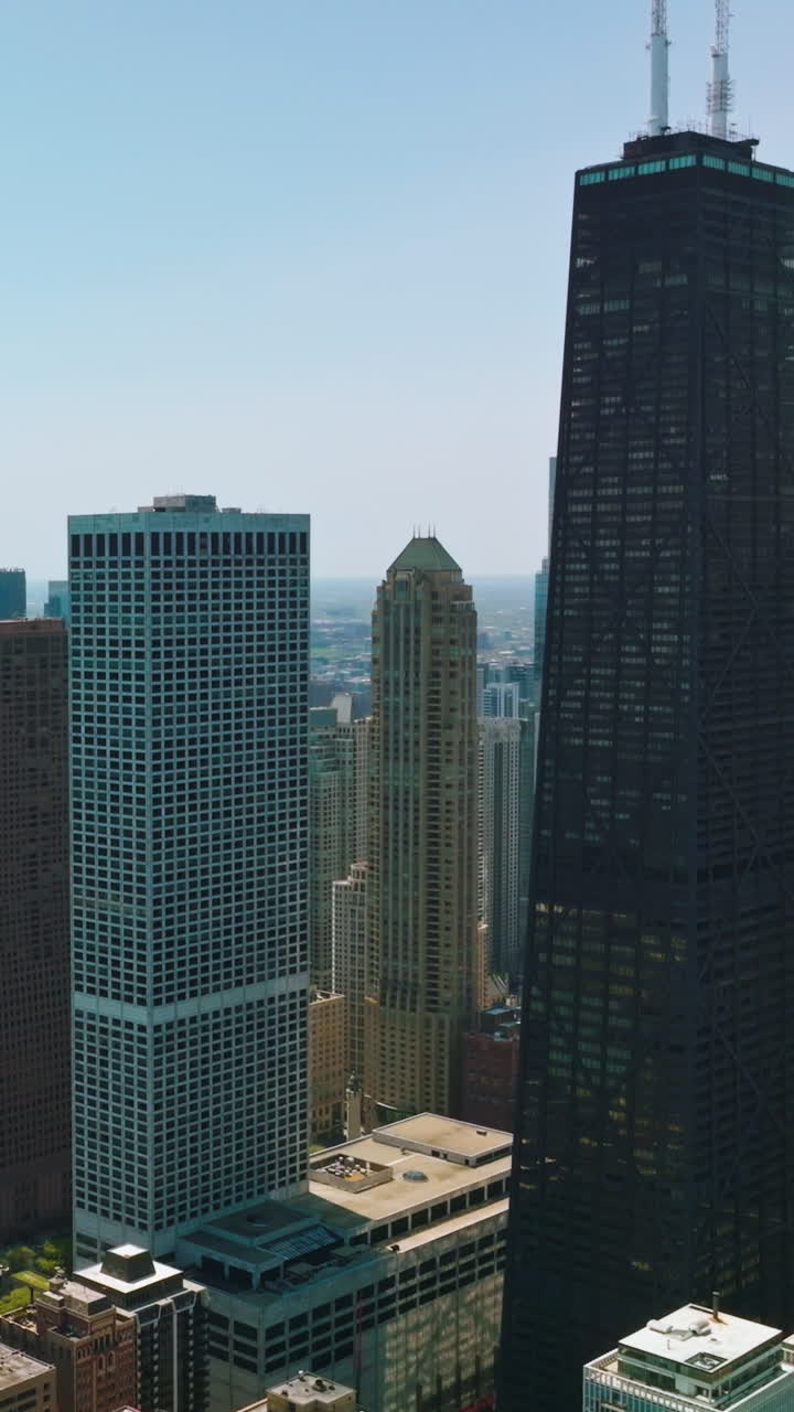Densely built-up urban territory. Multi-storied buildings and luxurious skyscrapers at the backdrop of blue clear sky. Vertical video