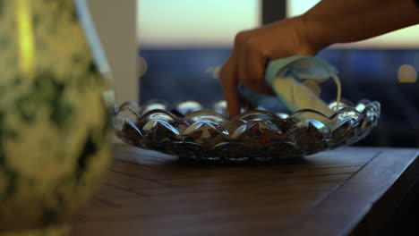 Woman's-Hand-Taking-Medical-Face-Mask-And-Keys-On-Bowl-In-The-Table-Before-Leaving