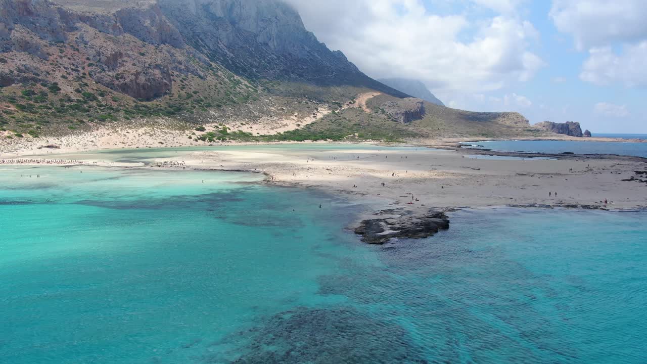 Balos Beach and saltwater lagoon in Crete Greece with the rocky division and turquoise blue water, Aerial lift flyover shot