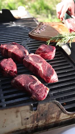 cooking rib-eye steaks on a grill