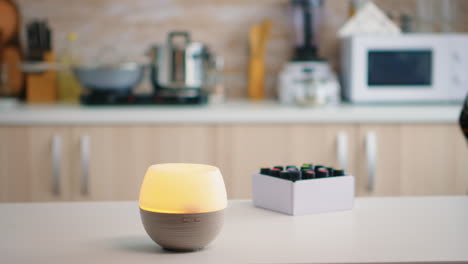 woman in the kitchen with essential oils diffuser