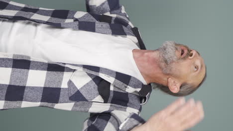 vertical video of the high air temperature is suffocating the old man.