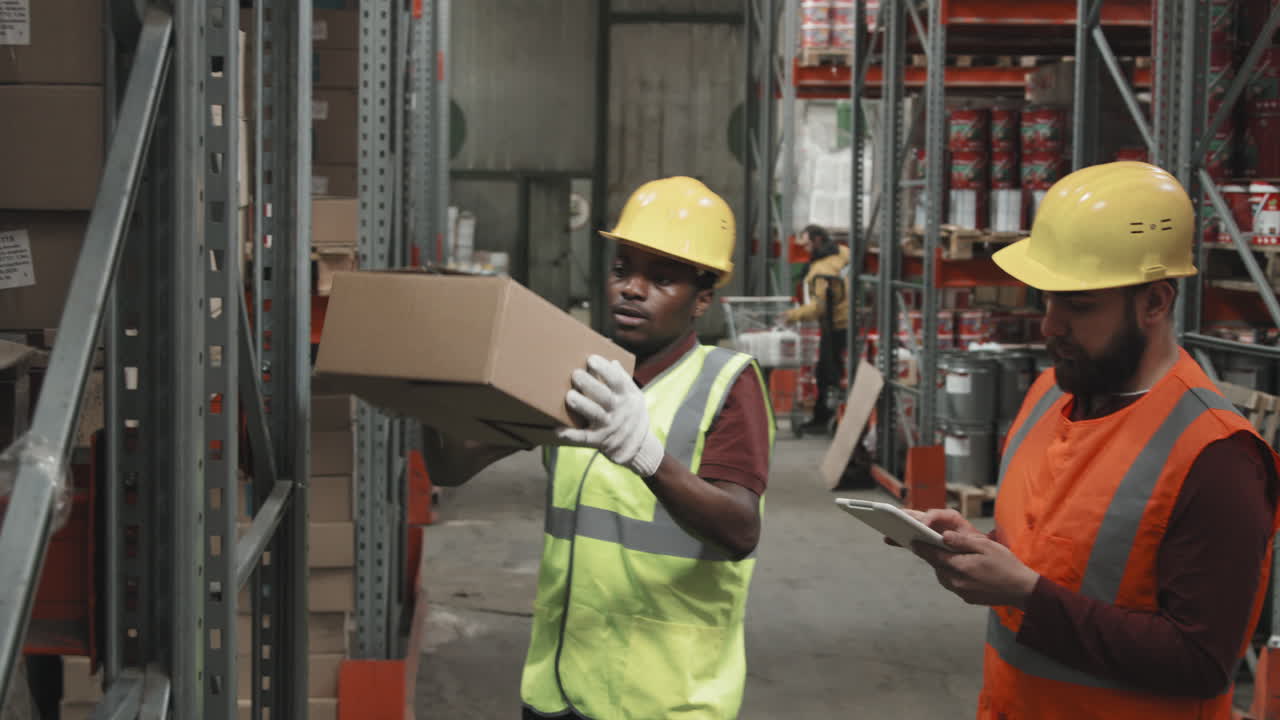 Male Warehouse Workers Checking Inventory