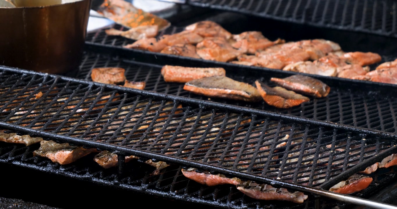 Grilling salmon outside in summertime.Gold Creek Salmon Bake.