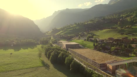 pushing-in-towards-bottom-station-of-tricable-car-system-Eiger-Express-in-Grindelwald-Terminal-in-picturesque-evening-light-in-Grindelwald-in-the-Swiss-Alps