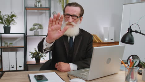 businessman working on laptop showing stop gestuge, danger, rejection, warning, crisis, prohibition
