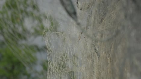 Close-up-of-a-fishing-net-hanging-outdoors-at-Renndølsetra-farm-in-Innerdalen,-Norway