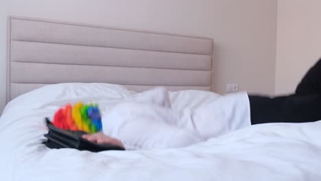 smiling young caucasian blonde man with stylish haircut holding gay pride flag smiling young caucasian blonde man with stylish haircut holding gay pride flag